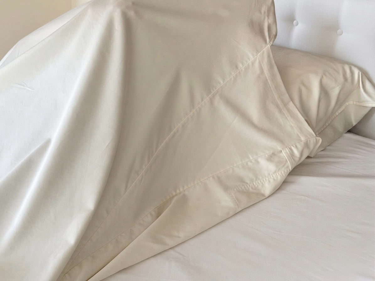 UpsideLuxe Sleep Sack in Egret ivory draped over pillow showing gusset and side seam