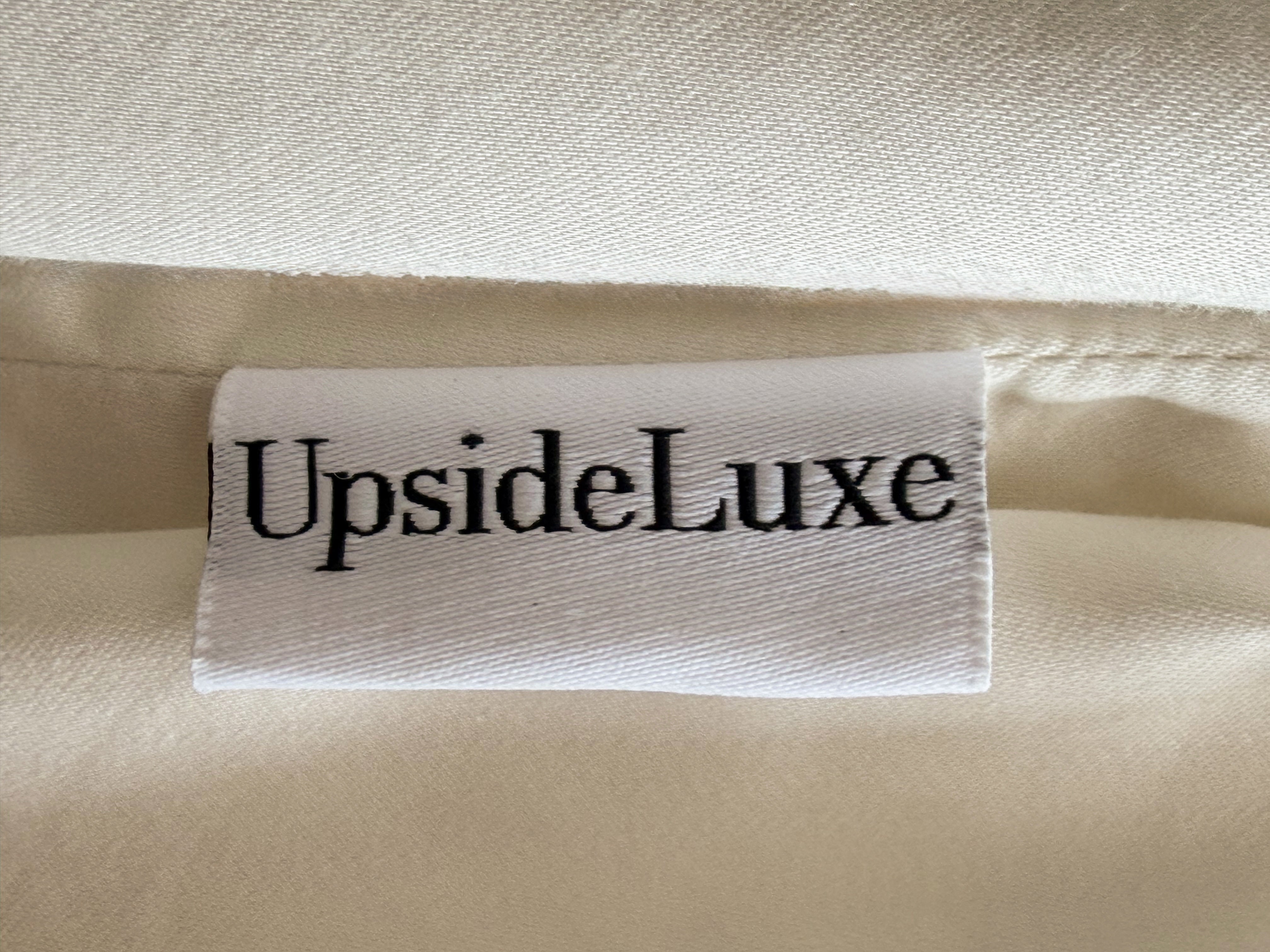 UpsideLuxe woven brand label on Egret ivory Supima cotton sateen